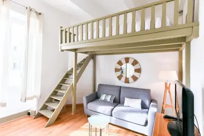 a living room with a couch and a loft at Studio élégant pour 4 personnes, à quelques pas de la Croisette in Cannes