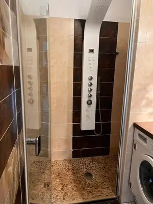 a shower with a glass door in a bathroom at Spacious 2-Bedroom Apartment with Terrace Prime Location in Cannes in Cannes