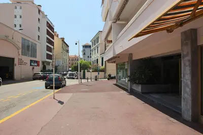 a sidewalk in a city with a car parked on the street at Spacious 2-Bedroom Apartment with Terrace Prime Location in Cannes in Cannes