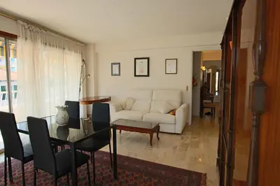 a living room with a white couch and a table at Spacious 2-Bedroom Apartment with Terrace Prime Location in Cannes in Cannes