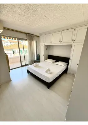 a bedroom with a bed and a large window at Spacious 2-Bedroom Apartment with Terrace Prime Location in Cannes in Cannes