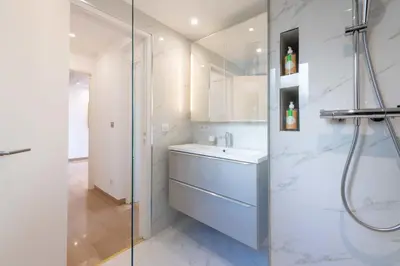 a bathroom with a sink and a shower at 3-Br Crossing Apartment Palm Beach in Cannes