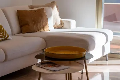 a living room with a couch and a table at 3-Br Crossing Apartment Palm Beach in Cannes
