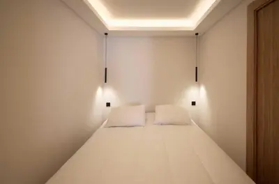 a small room with a bed with two white pillows at A C apt in the heart of Cannes—Croisette Beaches in Cannes