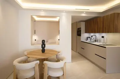 a kitchen and dining room with a table and chairs at A C apt in the heart of Cannes—Croisette Beaches in Cannes