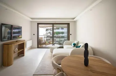 a living room with a couch and a table at A C apt in the heart of Cannes—Croisette Beaches in Cannes