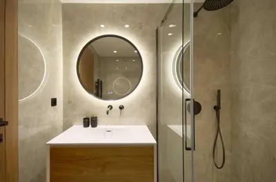 a bathroom with a sink and a shower with a mirror at A C apt in the heart of Cannes—Croisette Beaches in Cannes