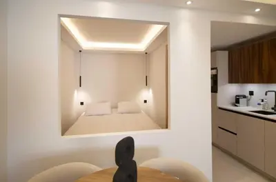 a mirror on the wall of a kitchen with a bed at A C apt in the heart of Cannes—Croisette Beaches in Cannes