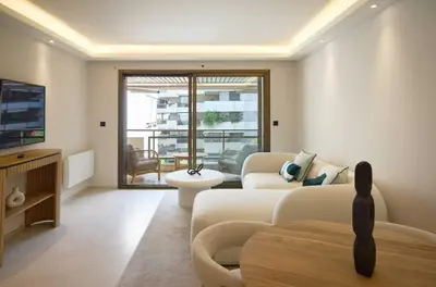 a living room with a couch and a tv at A C apt in the heart of Cannes—Croisette Beaches in Cannes