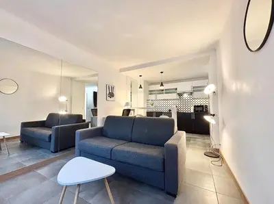 a living room with a couch and a table at Cannes 1 bedroom apartment - 57A2 in Cannes