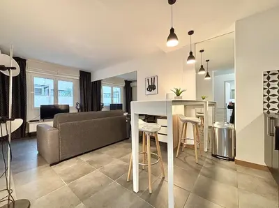 a kitchen and living room with a couch and a table at Cannes 1 bedroom apartment - 57A2 in Cannes