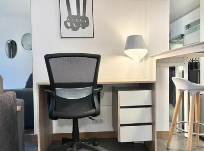a desk with a black chair and a lamp at Cannes 1 bedroom apartment - 57A2 in Cannes