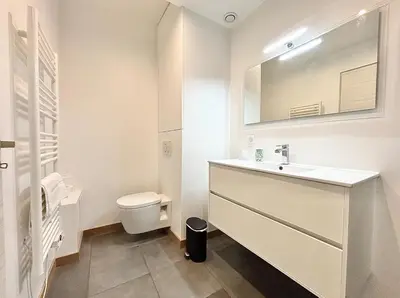 a white bathroom with a sink and a toilet at Cannes 1 bedroom apartment - 57A2 in Cannes