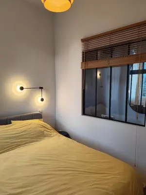 a bedroom with a bed with a window and towels at Cannes centre superbe 3 pièces moderne 10 min à pied du Palais des festivals et croisette in Cannes