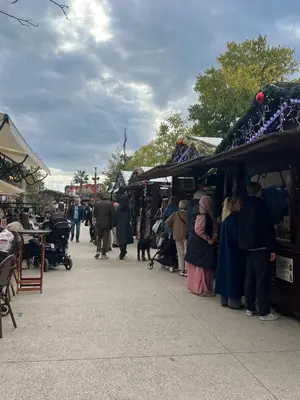 a group of people walking around an outdoor market at King size studio Rue Félix Faure 100 m Palais et plage in Cannes