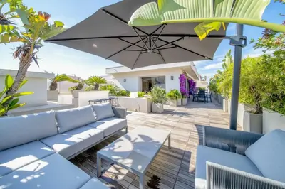 a patio with blue furniture and an umbrella at -CLR- Stunning suite with terrace in Cannes
