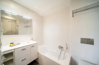 a white bathroom with a tub and a sink at -CLR- Stunning suite with terrace in Cannes