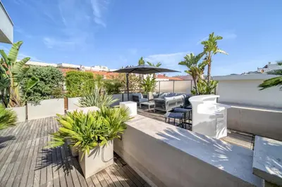 a patio with chairs and plants on a roof at -CLR- Stunning suite with terrace in Cannes