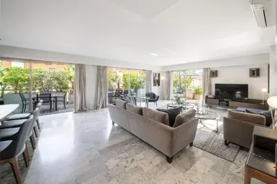 a large living room with couches and a television at -CLR- Stunning suite with terrace in Cannes