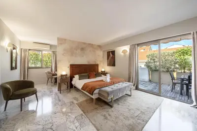 a bedroom with a bed and a balcony at -CLR- Stunning suite with terrace in Cannes