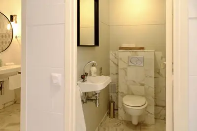 a bathroom with a toilet and a sink at Appartement de standing - quartier Martinez - 70m2 in Cannes