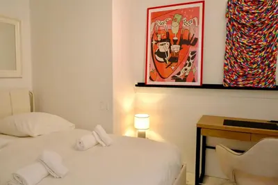 a room with two beds and a picture on the wall at Appartement de standing - quartier Martinez - 70m2 in Cannes