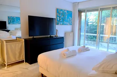 a bedroom with a bed with two stuffed animals on it at Appartement de standing - quartier Martinez - 70m2 in Cannes