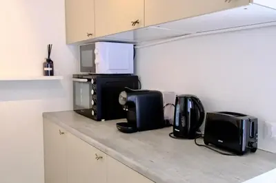 a kitchen counter with microwaves and appliances on it at Appartement de standing - quartier Martinez - 70m2 in Cannes