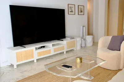 a living room with a large flat screen tv at Appartement de standing - quartier Martinez - 70m2 in Cannes