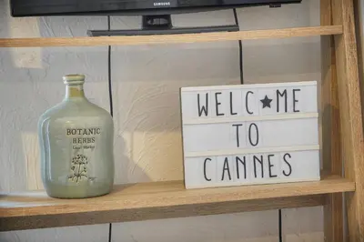 a shelf with two signs and a bottle on it at FRGK 