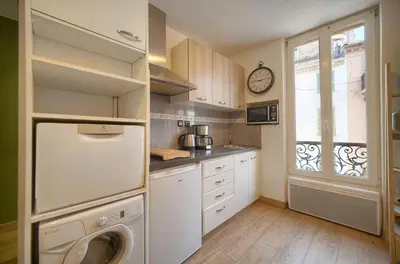 a kitchen with a white refrigerator and a window at FRGK 