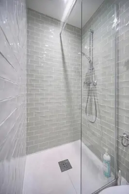 a bathroom with a shower with a glass door at FRGK 