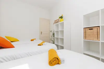 two beds in a room with white walls at BnGo l Ruby Suite l 2ch, 7p, vue mer, centre in Cannes