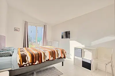 a bedroom with a bed and a dresser and a window at Villa Grand Jas in Cannes