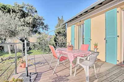 a patio with a table and chairs on a deck at Villa Grand Jas in Cannes