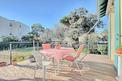 a patio with a table and chairs on a deck at Villa Grand Jas in Cannes