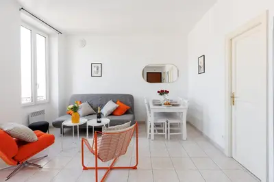 a living room with a couch and a table at BnGo l Amber Suite l 2ch, 6 personnes, centre in Cannes