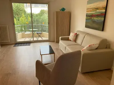 a living room with a couch and a table at Grand studio pointe croisette in Cannes