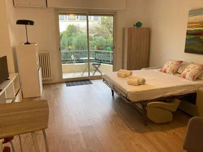 a bedroom with a bed and a large window at Grand studio pointe croisette in Cannes