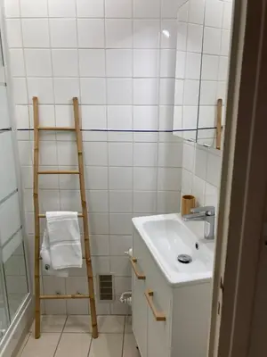 a white bathroom with a sink and a ladder at Grand studio pointe croisette in Cannes