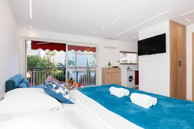 a bedroom with a large bed with two pillows at Santa Cruz YourHostHelper in Cannes