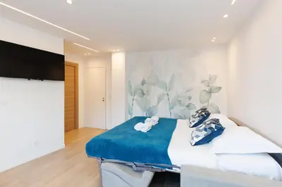 a bedroom with a bed and a flat screen tv at Santa Cruz YourHostHelper in Cannes
