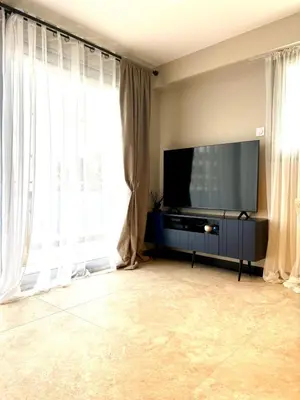 a living room with a flat screen tv and windows at Appartement cosy proche de la Croisette in Cannes