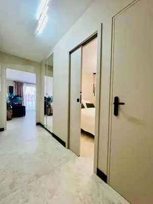 an empty room with a door and a bedroom at Appartement cosy proche de la Croisette in Cannes