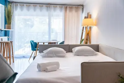 a bed with two pillows on it in a room at 2 pièces - Centre-ville Cannes - Grand lit double in Cannes