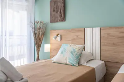 a bedroom with a bed with a pillow on it at 2 pièces - Centre-ville Cannes - Grand lit double in Cannes