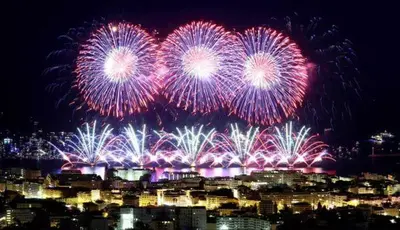 a fireworks display over a city at night at Chez Marie et Baptiste, bel appartement en résidence avec piscine, tennis in Le Cannet