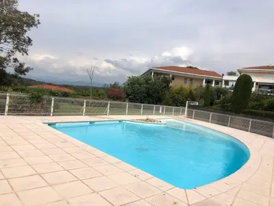 a large blue swimming pool in a yard at Chez Marie et Baptiste, bel appartement en résidence avec piscine, tennis in Le Cannet