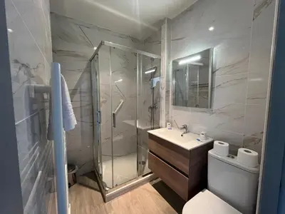 a bathroom with a shower and a toilet and a sink at Hôtel-résidence-Windsor in Cannes