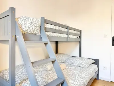 a gray bunk bed with a ladder next to a bunk bedouble at Le Palme d'Or, 3 pièces - impasse privée - 7 pers in Cannes